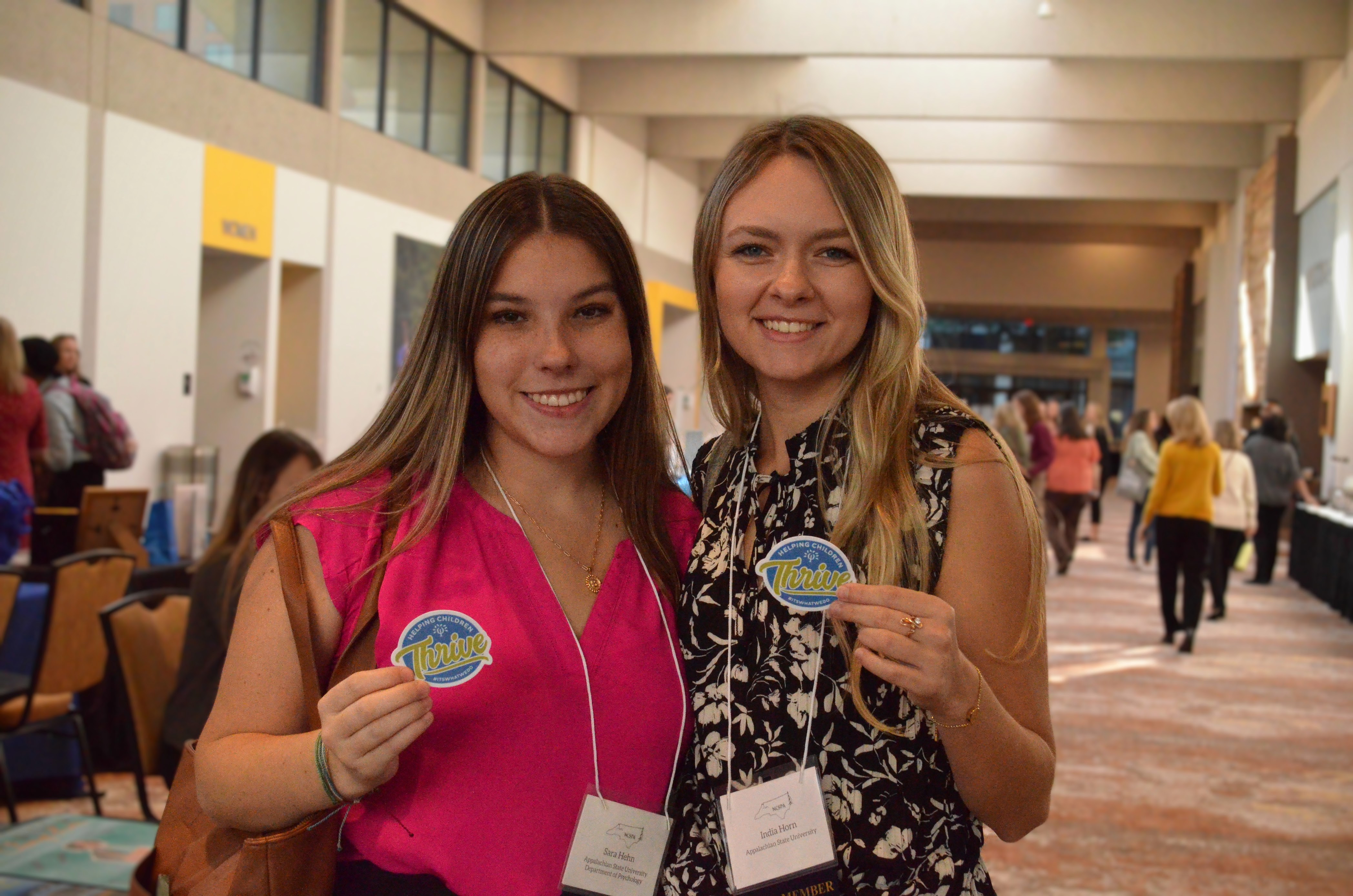 two people holding stickers